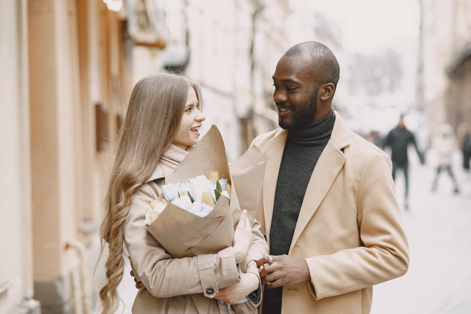 Young couple enjoying a romantic stroll with flowers on a city street. Perfect depiction of love and connection.
