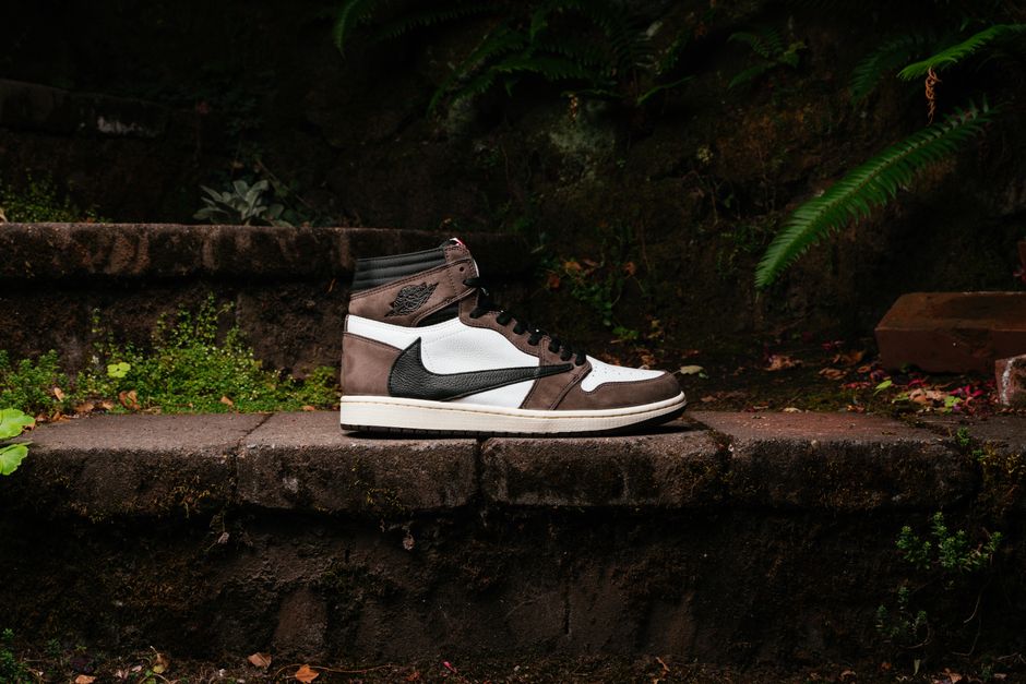 Sneaker on stone steps surrounded by lush greenery. Perfect for sports fashion.