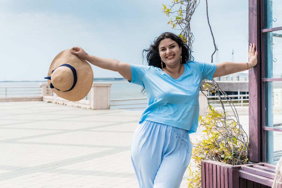 Happy woman enjoying a sunny day at Baku waterfront in Azerbaijan.